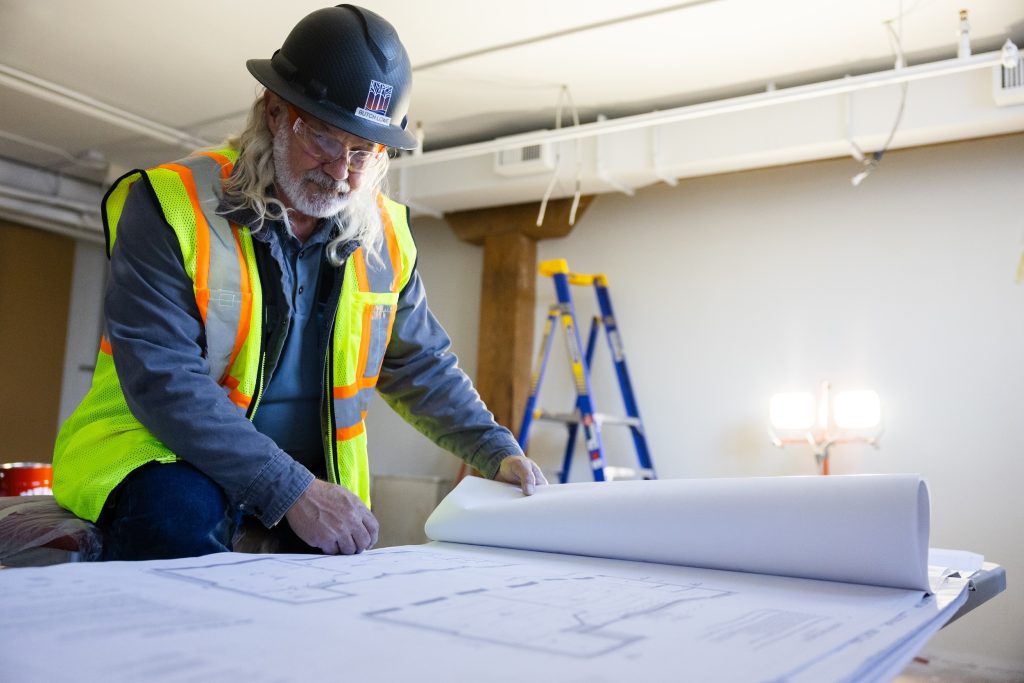 Riverstone superintendent reviewing construction plans on a commercial jobsite